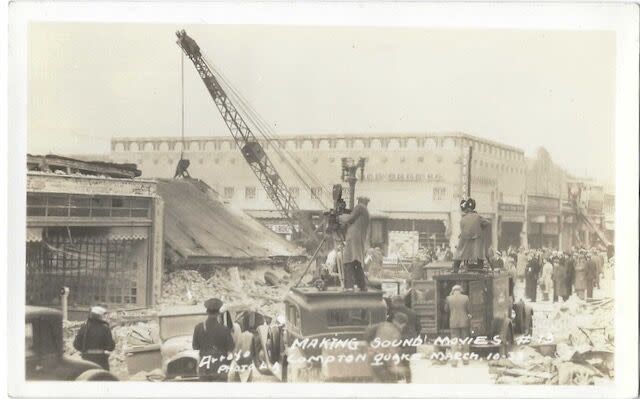 A postcard shows filmmakers recording cranes working on buildings damaged by the 1933 Long Beach earthquake.