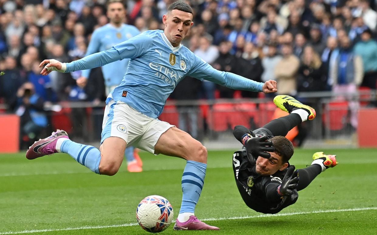 Phil Foden goes around Chelsea goalkeeper Djordje Petrovic during the FA Cup semi-final between Manchester City and Chelsea, April 20, 2024