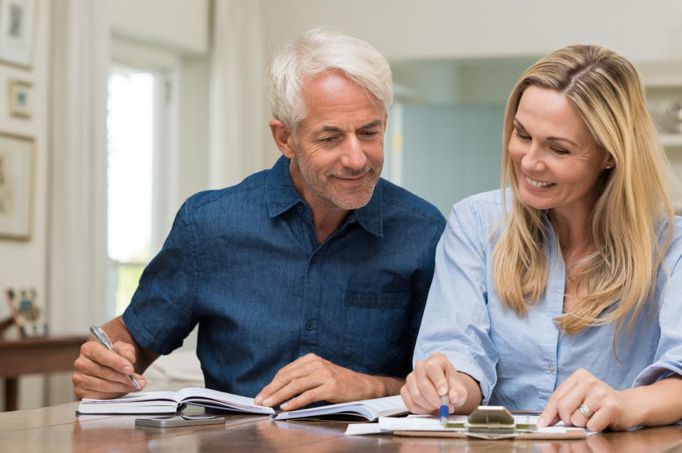 Mature couple happily discussing finances