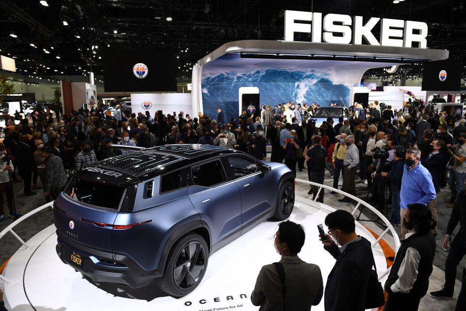 Attendees view the Fisker Ocean electric vehicle after its unveiling during AutoMobility LA ahead of the Los Angeles Auto Show on November 17, 2021 in Los Angeles, California. (Photo by Patrick T. FALLON / AFP) (Photo by PATRICK T. FALLON/AFP via Getty Images)