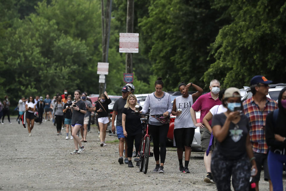 People wait in line to vote in the Georgia's primary election at Park Tavern on Tuesday, June 9, 2020, in Atlanta. (AP Photo/Brynn Anderson)