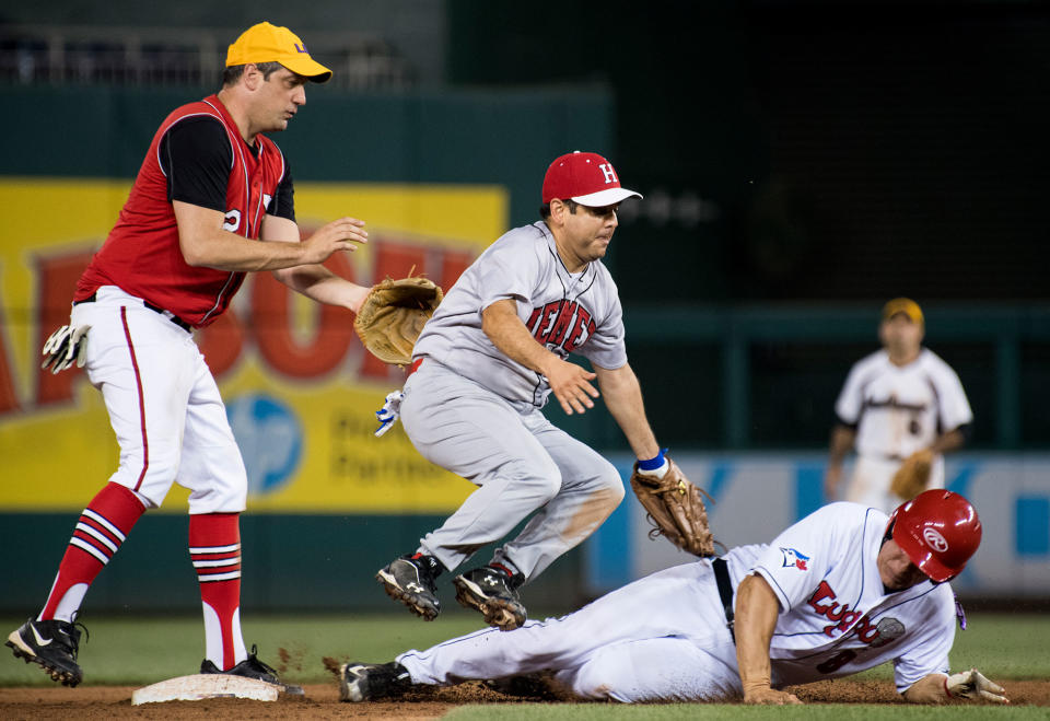 <p>Rep. Raul Ruiz, D-Calif., tags out Rep. Mike Bishop, R-Mich., at second base as Rep. Tim Ryan, D-Ohio, watches during the annual Congressional Baseball Game at Nationals Park in Washington on Thursday, June 15, 2017. (Photo: Bill Clark/CQ Roll Call/Getty Images) </p>