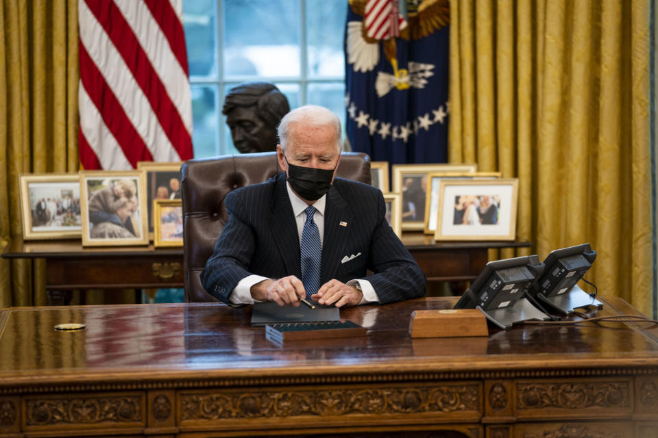 President Joe Biden prepares to sign an executive order in the Oval Office of the White House on Jan. 25, repealing the ban on transgender people serving openly in the military. (Photo: Doug Mills-Pool/Getty Images)