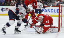 Columbus Blue Jackets center Boone Jenner (38) has his attempt to score stopped by Detroit Red Wings goaltender James Reimer (47) during the second period of an NHL hockey game Tuesday, March 19, 2024, in Detroit. (AP Photo/Duane Burleson)