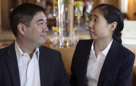 Grace and Matthew (L) Huang, a U.S. couple who were sentenced to three years in jail in Qatar in April for causing the death of their adopted daughter Gloria, sit together ahead of a meeting with U.S. ambassador to Qatar Dana Shell Smith in Doha, October 19, 2014. REUTERS/Fadi Al-Assaad