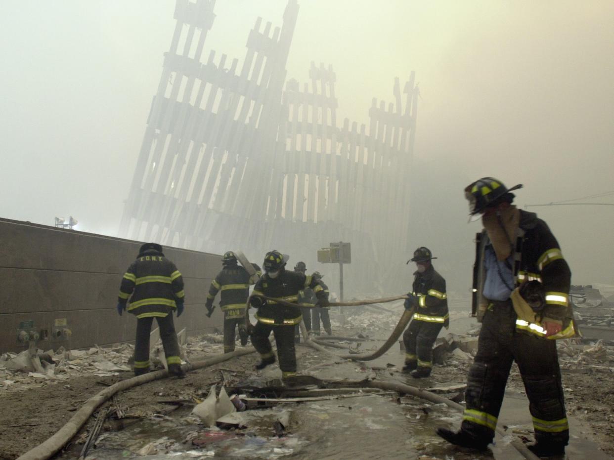 Firefighters work on Sept. 11, 2001 at the destroyed World Trade Center after a terrorist attack on the twin towers in New York. The attacks in New York City and Washington killed almost 3,000 people and led to war in Afghanistan. (AP Photo/Mark Lennihan)