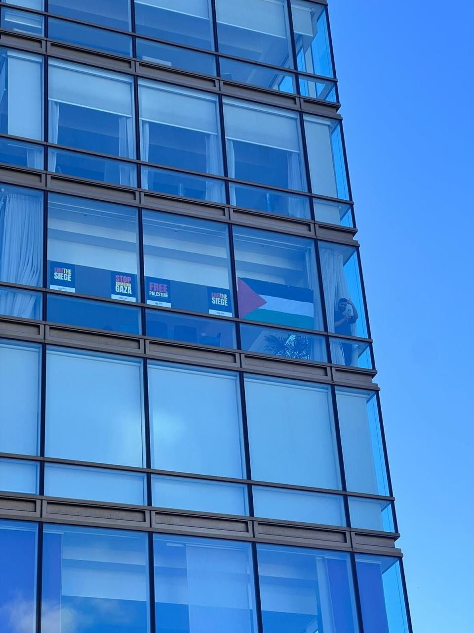 One man supports the call for a ceasefire from high above in his skyrise flat (Provided)