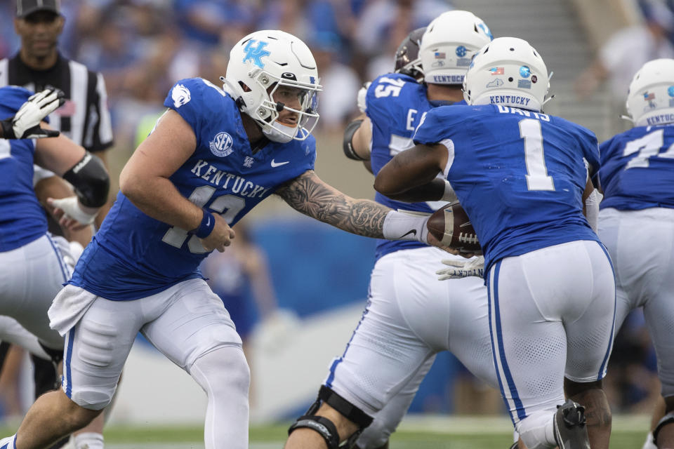 Kentucky quarterback Devin Leary (13) hands the ball off to running back Ray Davis (1) during the second half of an NCAA college football game against Eastern Kentucky in Lexington, Ky., Saturday, Sept. 9, 2023. (AP Photo/Michelle Haas Hutchins)