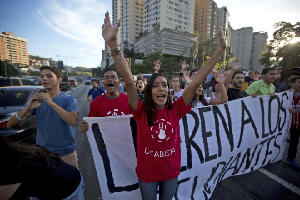 Opposition members shout slogans against Venezuela's President Nicolas Maduro during a protest, in Caracas, Venezuela, Friday, March 31, 2017. Venezuelans have been thrust into a new round of political turbulence after the government-stacked Supreme Court gutted congress of its last vestiges of power, drawing widespread condemnation from foreign governments and sparking protests in the capital. (AP Photo/Fernando Llano)