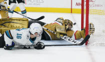 San Jose Sharks center Ryan Donato (16) attempts a shot on Vegas Golden Knights goaltender Marc-Andre Fleury (29) during the third period of an NHL hockey game Wednesday, April 21, 2021, in Las Vegas. (AP Photo/John Locher)