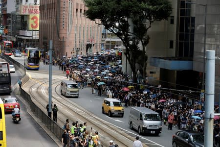 People carry umbrellas as they attend a protest in Hong Kong