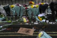 Flowers and candles are placed besides a placard that reads "Want freedom, not to be a puppet", outside the Chinese embassy in London, Monday Nov. 28, 2022. Demonstrators gathered outside the Chinese embassy in London on Sunday night, in solidarity over unrest in China. Barely a month after granting himself new powers as China’s potential leader for life, Xi Jinping is facing a wave of public anger of the kind not seen for decades, sparked by his “zero COVID” strategy that will soon enter its fourth year. (AP Photo/Kin Cheung)