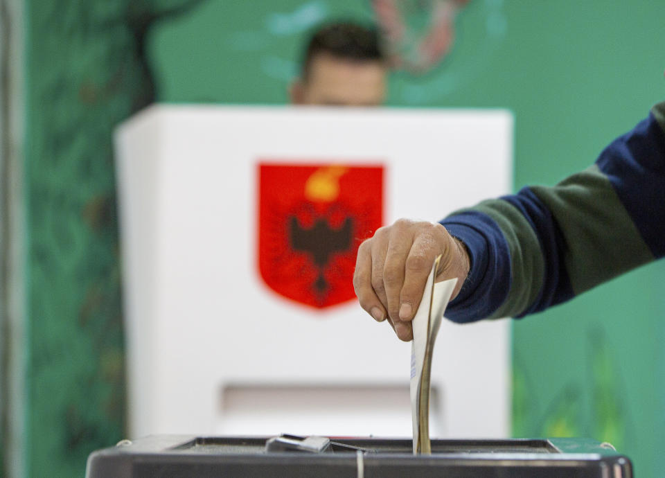 A man casts his vote during parliamentary elections in capital Tirana, Albania, Sunday, April 25, 2021. Albanian voters have started casting ballots in parliamentary elections on Sunday amid the virus pandemic and a bitter political rivalry between the country's two largest political parties. (AP Photo/Visar Kryeziu)