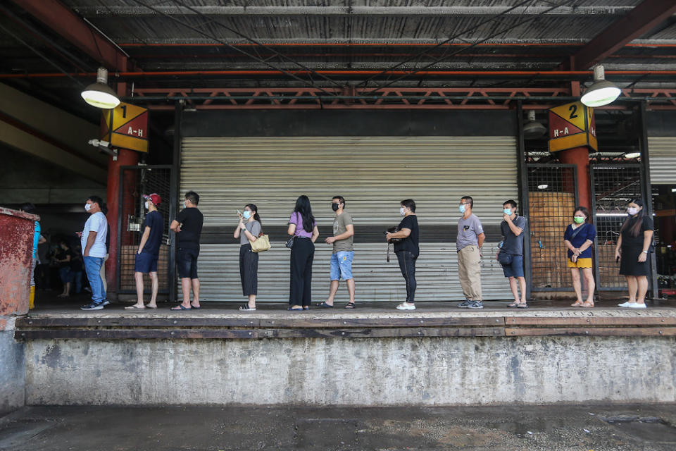 Traders and workers at Pasar Borong Kuala Lumpur queue to receive their Covid-19 vaccination through the MYMedic@Wilayah Vaccine Mobile Truck programme in Selayang June 20, 2021. — Picture by Yusof Mat Isa