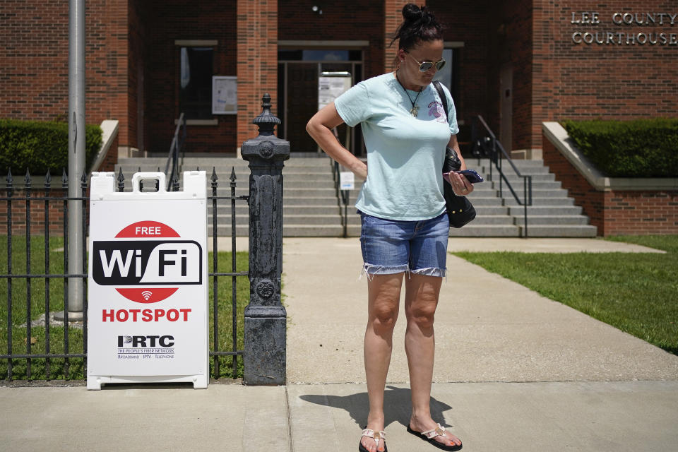 Susanne Willis stands in front of the Lee County Courthhouse while using the public WIFI, in Beattyville, Ky., Wednesday, July 29, 2020. 