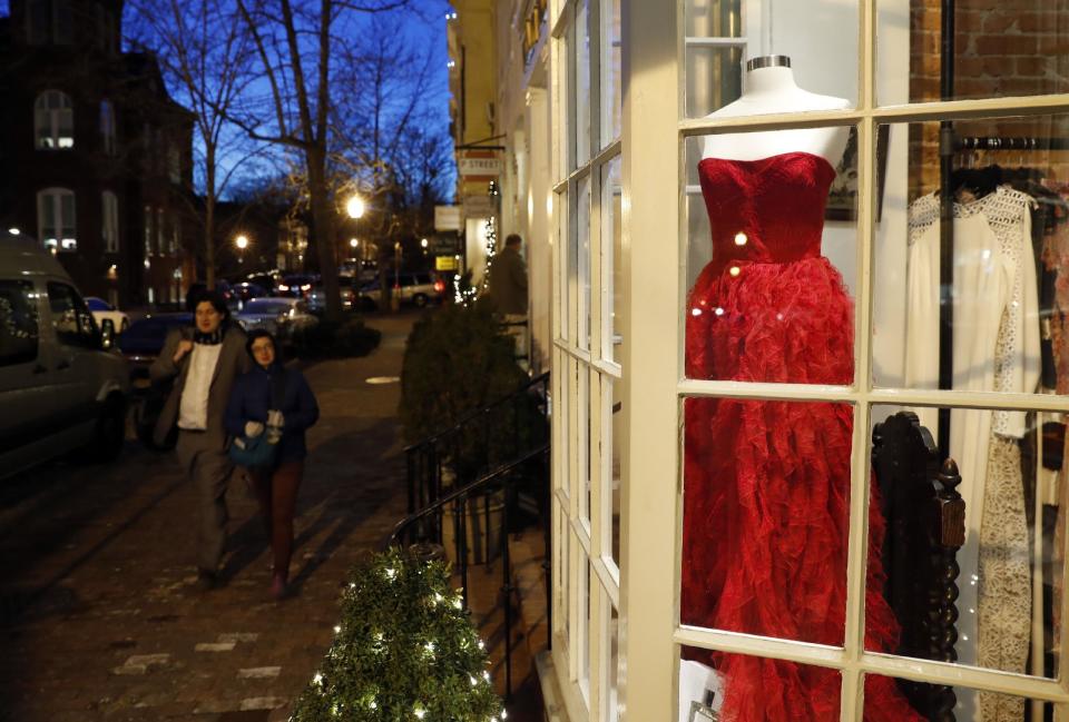 Designer dresses are for sale at Ella-Rue including this red Badgley Mischka for $795 seen in the window, Monday, Jan. 9, 2017 in the Georgetown area of Washington. Ladies in Washington planning to celebrate Donald Trump's inauguration as the next president won't, it turns out, need a fairy godmother to find something to wear. The president-elect told The New York Times in an interview published Monday that enthusiasm was so high for the arrival of his administration that turnout for the Jan. 20 events will be "unbelievable, perhaps record-setting." "We've definitely had a lot of people come in in the last week for gowns, but we have plenty here," said Krista Johnson, owner of Ella-Rue. (AP Photo/Alex Brandon)