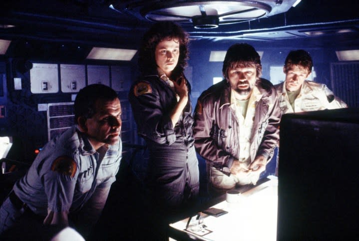 Four people look at a computer in Alien.