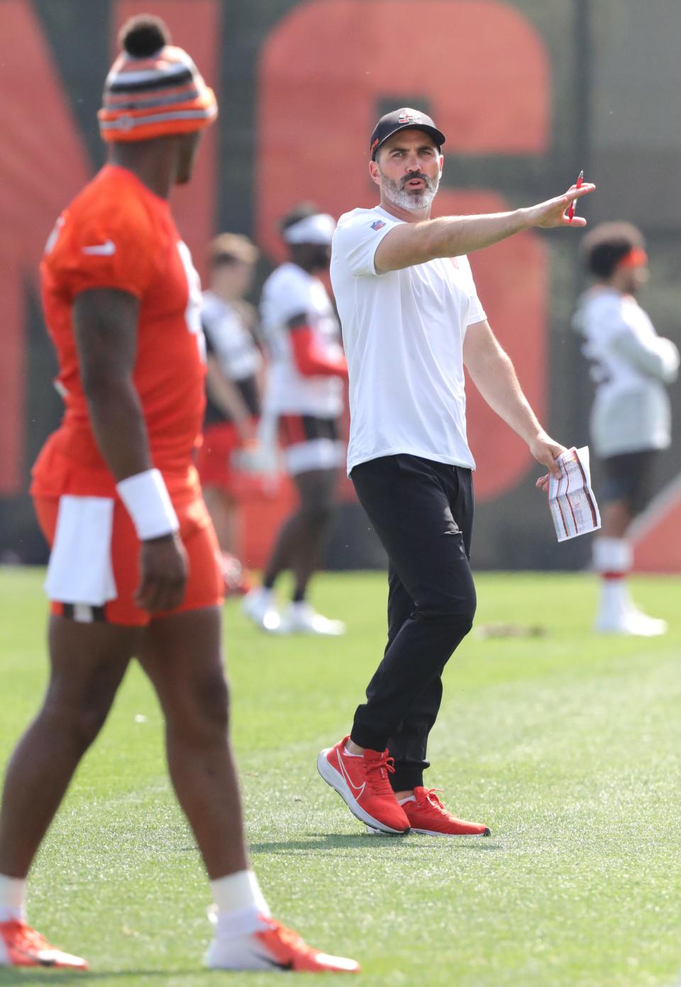 Cleveland Browns quarterback Deshaun Watson listens to head coach Kevin Stefanski during OTA workouts on Wednesday, June 8, 2022 in Berea.