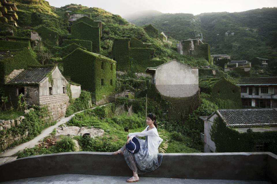 Wider Image: Creeping Vines, Abandoned Village