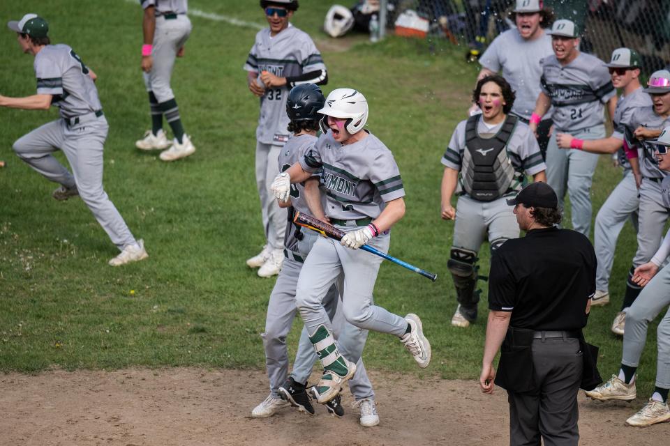 Oakmont baseball players celebrate after Ben Forbes hit a walk-off single in the bottom of the seventh to lift the Spartans to a 3-2 win over St. Paul.