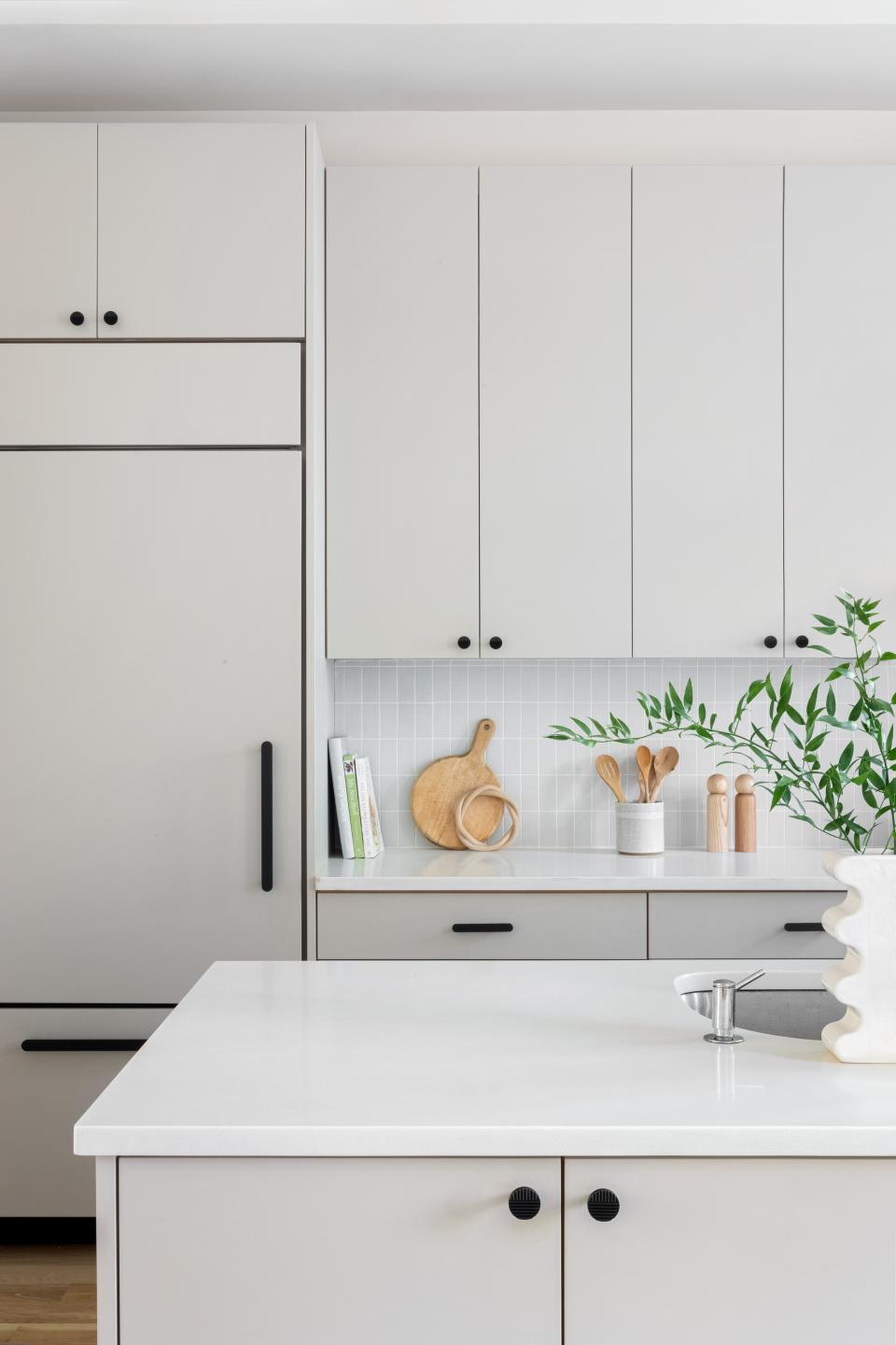 “We wanted to quiet the space without wasting or spending too much,” Sheena explains. “So we didn’t replace anything but the hardware. The cabinets were removed and painted off-site, and we added matte black Park Studio L.A. hardware—easy!”