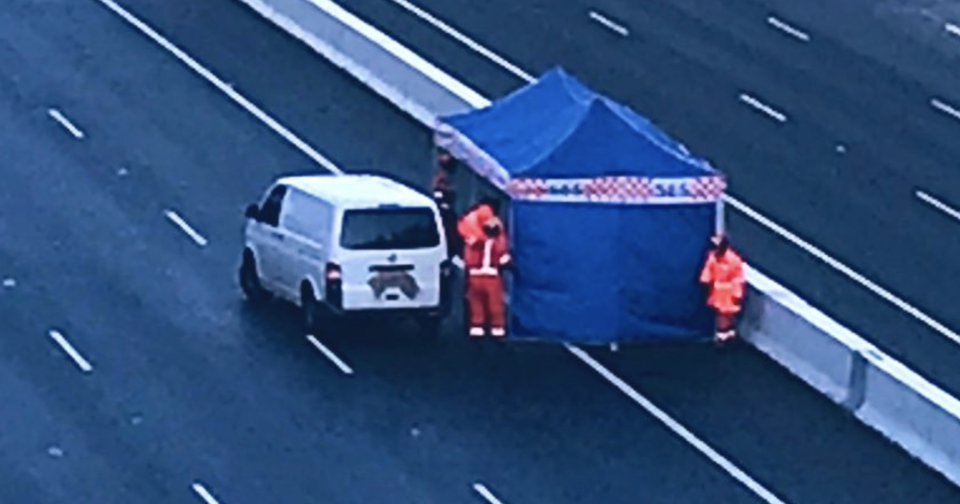 Pictured is an SES tent on the Eastlink freeway in Melbourne next to a white van. 