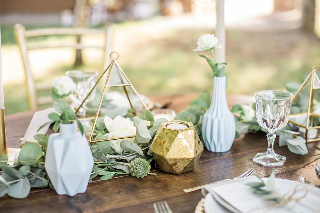 Decorated wedding table with geometric vases and plants