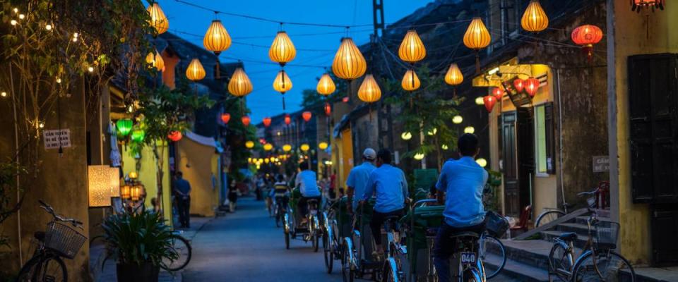 Night view of busy street in Hoi An, Vietnam. Hoi An is the World's Cultural heritage site, famous for mixed cultures and architecture.