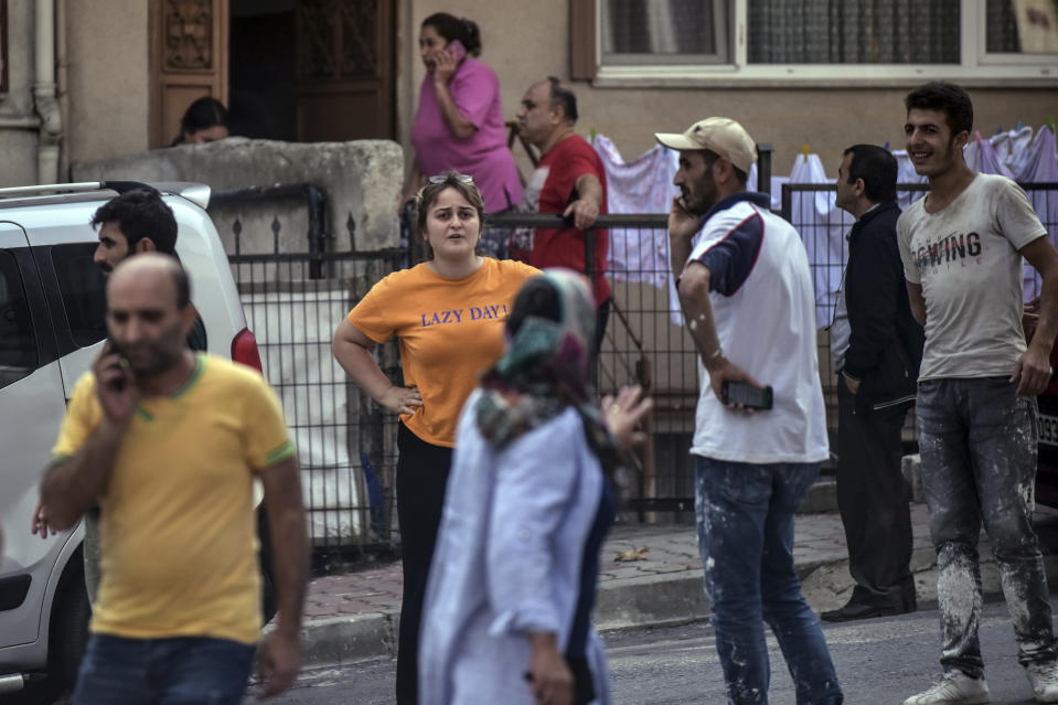 People stand on the streets after evacuating their homes, following an earthquake in Istanbul, Thursday, Sept. 26, 2019. Turkey's emergency authority says a 5.8 magnitude earthquake has shaken Istanbul with no immediate damage reported. (DHA via AP)