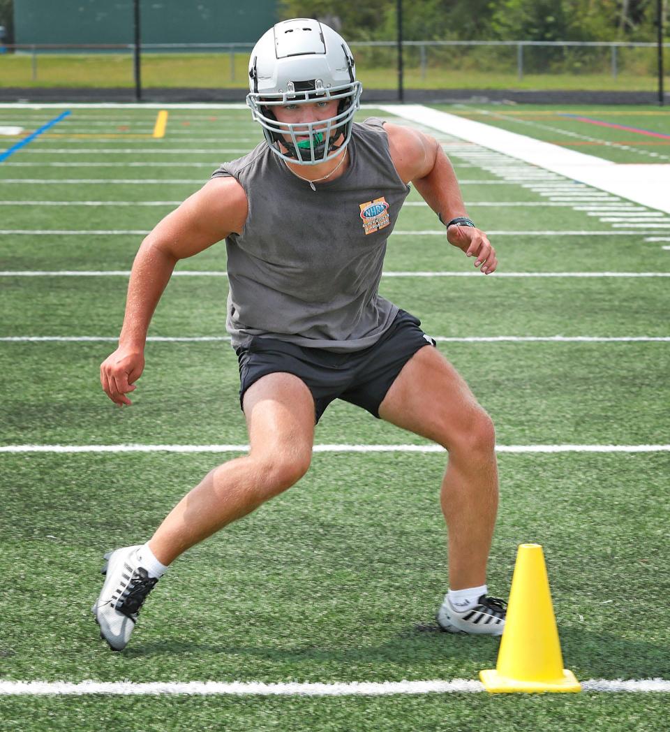 Senior Alex Barlow, a returning starter at running back and linebacker, works out during Duxbury High football practice on Monday, Aug. 21, 2023.