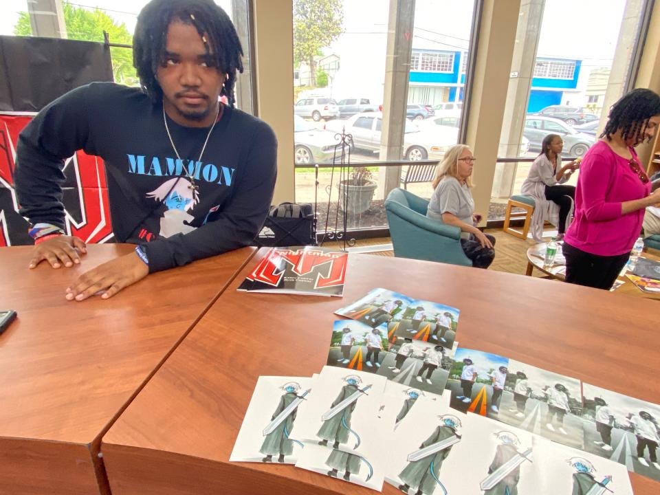 Kanye Conway signs copies of his second graphic novel, titled, “Mammon,” created with cousin Ryon Conway, at the Maury County Public Library, a year after their first release of "Nightman."