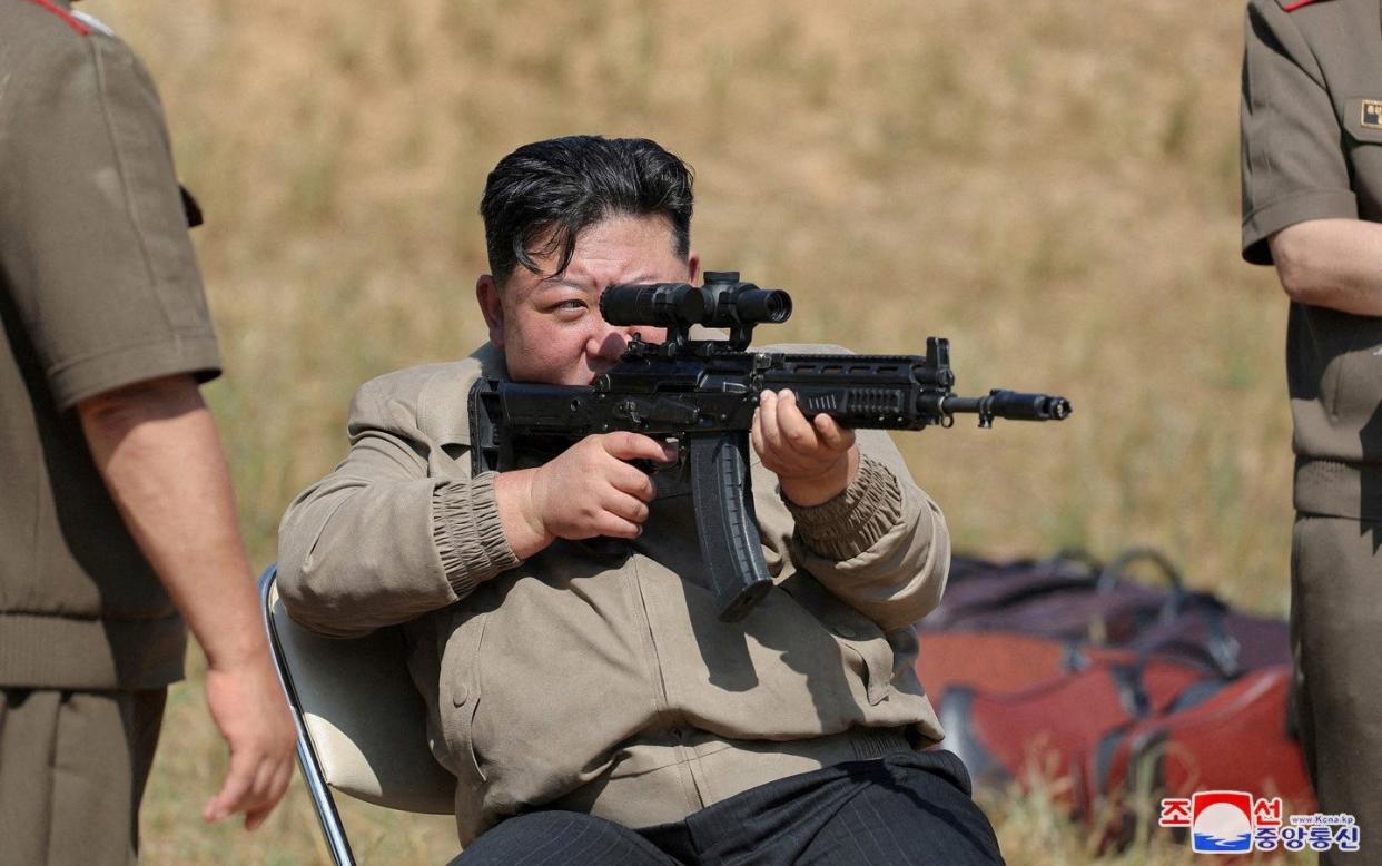 Kim also visited a training base where he aimed a rifle and inspected troops