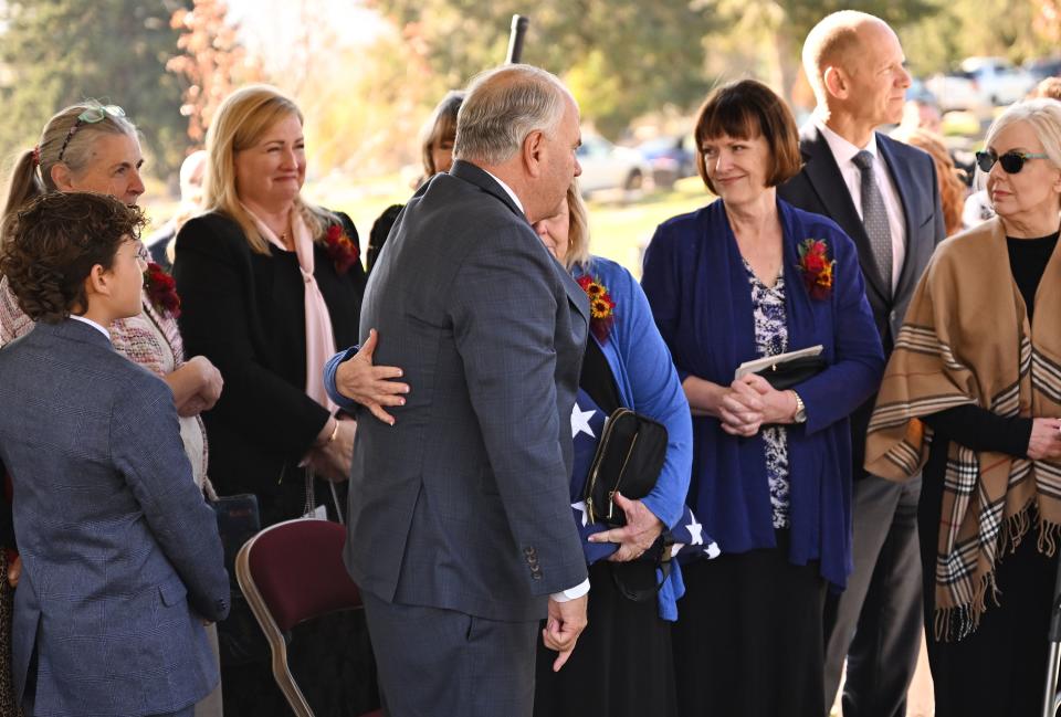 Elder Ronald A. Rasband of the Quorum of the Twelve Apostles hugs one of President M. Russell Ballard’s daughters, Holly Clayton, after the graveside service for President Ballard in the Salt Lake City Cemetery on Friday, Nov. 17, 2023. | Scott G Winterton, Deseret News