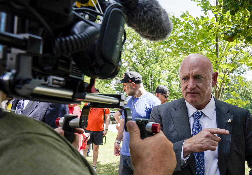 Sen. Mark Kelly, D-Ariz., speaks with members of the media as veterans, military family members and advocates, rally outside the Capitol in Washington on Aug. 2, 2022, in support of a bill that enhances health care and disability benefits for millions of veterans exposed to the toxic burn pits. (Mariam Zuhaib / AP)