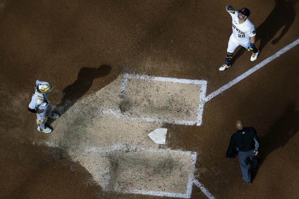 Milwaukee Brewers' Daniel Vogelbach reacts after hitting a two-run home run during the seventh inning of a baseball game against the Pittsburgh Pirates Sunday, April 18, 2021, in Milwaukee. (AP Photo/Morry Gash)