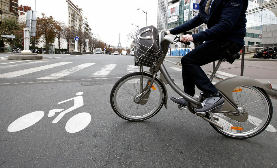 Johan Maige from Paris, rides a Velib bike-sharing program between cars in Paris, Tuesday, Oct. 30, 2012. From London’s “cycle superhighways” to popular bike-sharing programs in Paris and Barcelona, growing numbers of European cities are embracing cycling as a safe, clean, healthy, inexpensive and even trendy way to get around town. (AP Photo/Francois Mori)