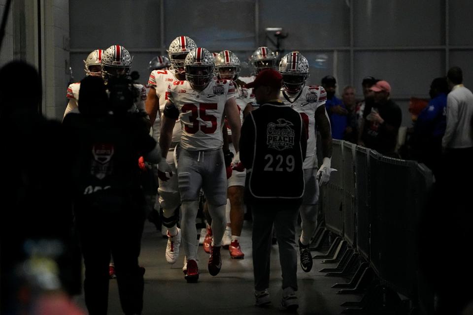 Dec 31, 2022; Atlanta, Georgia, USA; Ohio State Buckeyes linebacker Tommy Eichenberg (35) leads his team out of the locker room prior to the Peach Bowl in the College Football Playoff semifinal at Mercedes-Benz Stadium. Mandatory Credit: Adam Cairns-The Columbus Dispatch