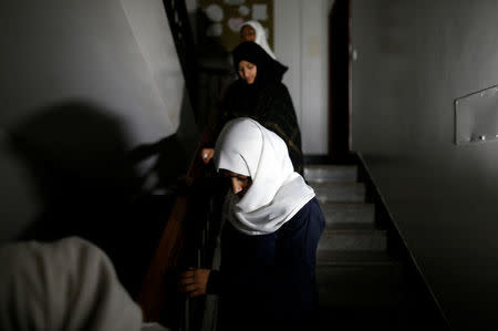 Girls walk down the stairs at an orphanage in Sanaa, Yemen, December 26, 2016. REUTERS/Khaled Abdullah