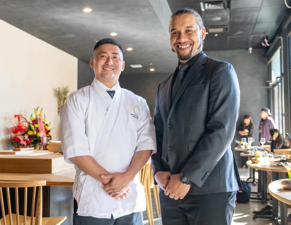 Executive Chef Hieu Phan, left, and Front of House Manager Michael Evans, right, greet guests during the grand opening of Okesutora on Wednesday, Oct. 18, 2023.
