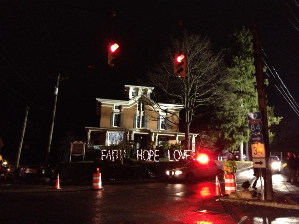 A message displayed in front of a home near Sandy Hook Elementary School in Newtown, Conn., reads: Faith, hope and love.