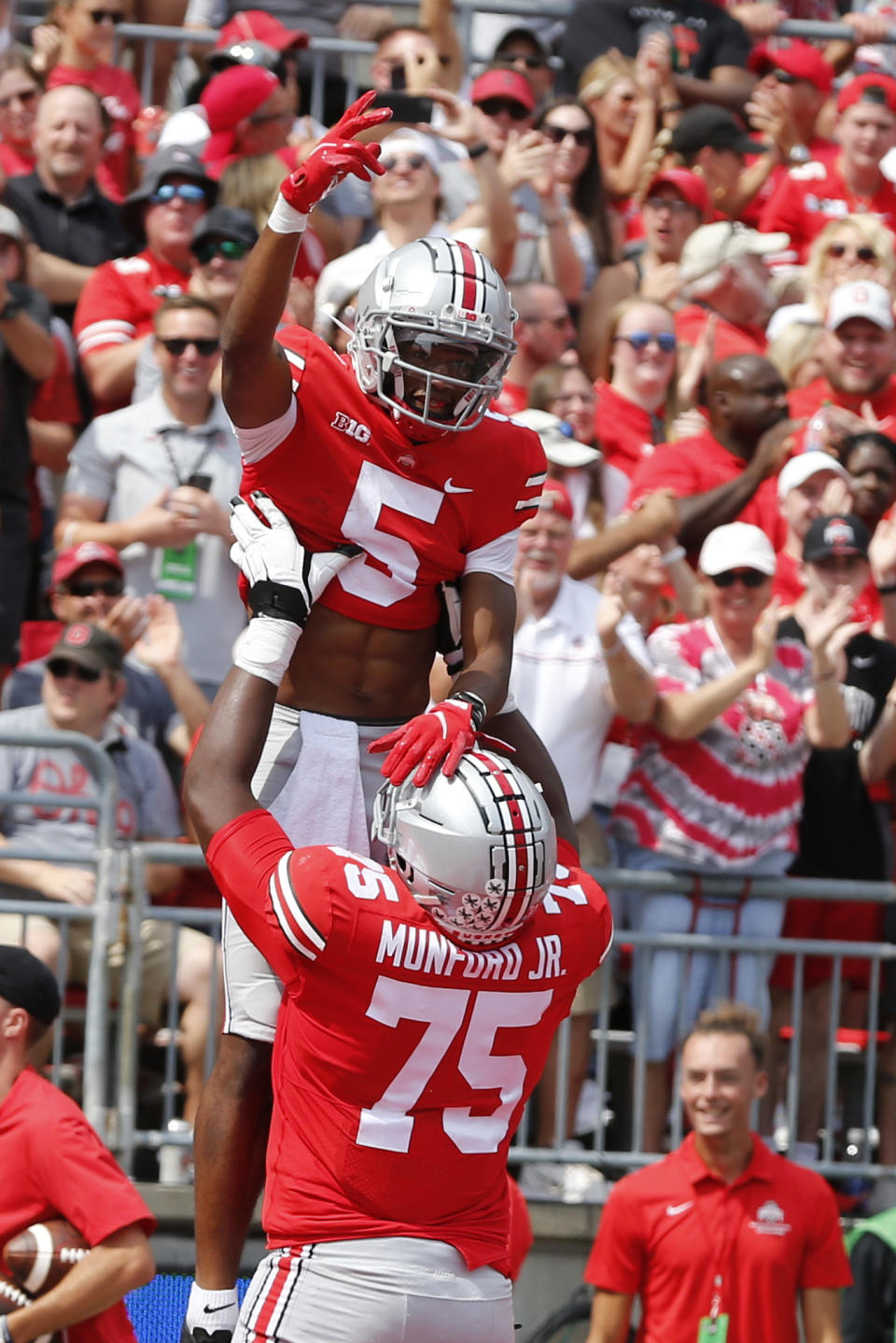 Ohio State receiver Garrett Wilson, top, celebrates his touchdown against Oregon with teammate offensive lineman Thayer Munford during the first half of an NCAA college football game Saturday, Sept. 11, 2021, in Columbus, Ohio. (AP Photo/Jay LaPrete)
