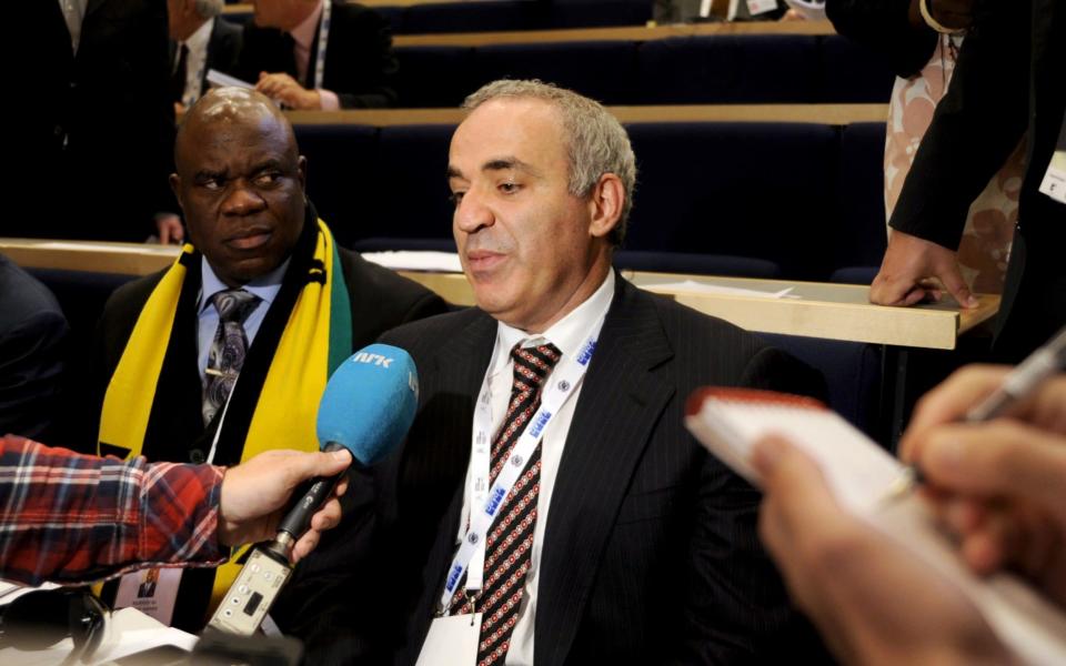 Russian former chess champion Garry Kasparov (R) answers journalists' questions after he lost the Fide presidential election in Tromso, Norway - Credit:  RUNE STOLTZ BERTINUSSEN