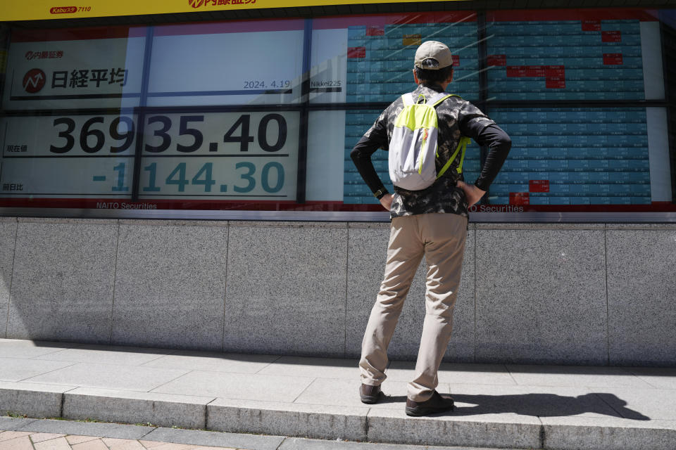 A person looks at an electronic stock board showing Japan's Nikkei 225 index at a securities firm Friday, April 19, 2024, in Tokyo. (AP Photo/Eugene Hoshiko)