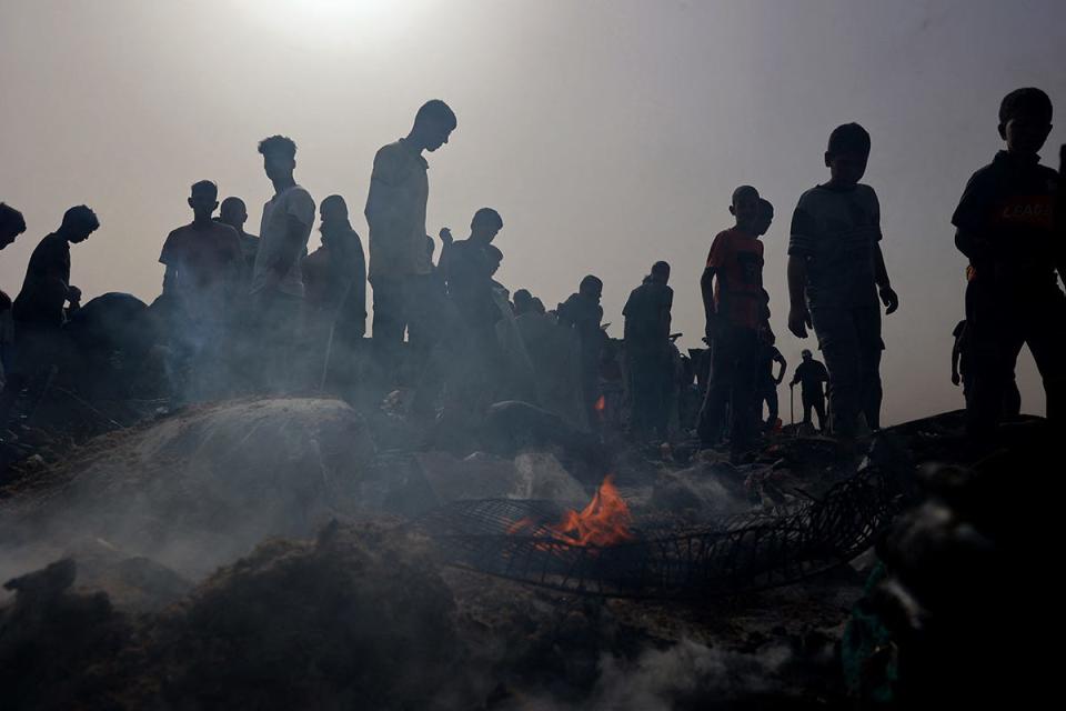 Palestinians gather at the site of an Israeli strike on a camp for internally displaced people in Rafah on May 27, 2024, amid ongoing battles between Israel and the Palestinian Hamas militant group. The Palestinian Authority and the militant group Hamas said Israeli strikes on a centre for displaced people killed dozens near the southern city of Rafah on May 26, while the Israeli army said it had targeted Hamas militants.