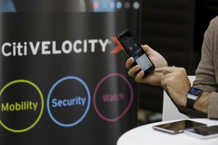 An employee demonstrates how to use the mobile app for "Citi Velocity" developed by Citi at their tech hub in Tel Aviv, Israel December 14, 2015. REUTERS/Amir Cohen