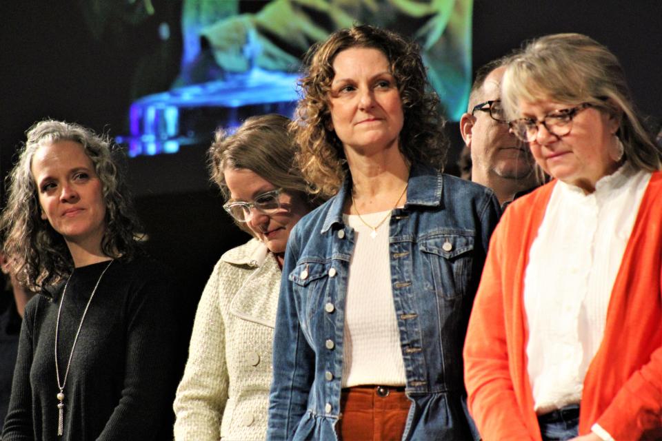 Jennifer Crisp, second from right, listens during the Feb. 19 ordination of eight elders at Highland Church of Christ. She is flanked by her sisters on the leadership team - from left, Dava Lynn Sullivan, Beth Ann Fisher and Julie Danley.