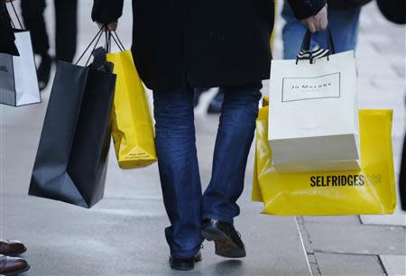 Shoppers walk along Oxford Street on the last Sunday before Christmas in London December 22, 2013. REUTERS/Luke MacGregor