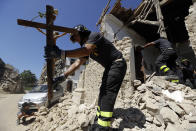 <p>A cross made with ladders and firefighter helmets is placed inside a tent during a Mass celebrated by Bishop Giovanni D’Ercole at a tent camp set up as a temporary shelter for the earthquake survivors in Arquata Del Tronto, near Amatrice, central Italy, Aug. 28, 2016. (AP Photo/Gregorio Borgia) </p>