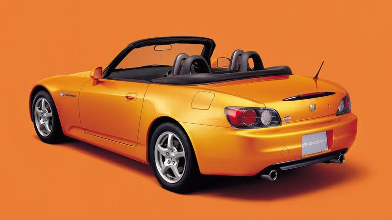 Image of a gold Honda S2000 on an orange background.