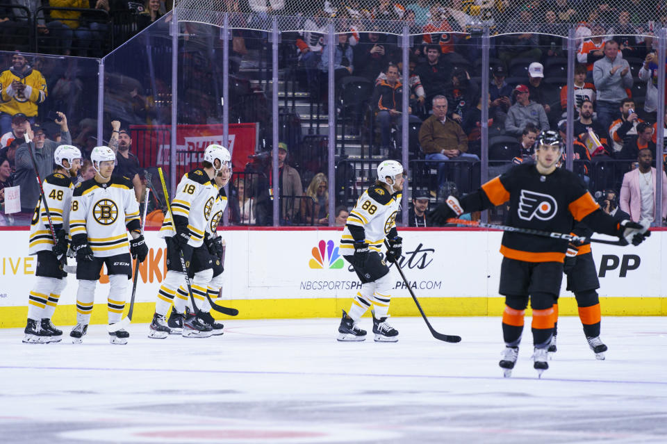 Boston Bruins' David Pastrnak, second from left, celebrates his second goal with teammates during the second period of an NHL hockey game against the Philadelphia Flyers, Sunday, April 9, 2023, in Philadelphia. (AP Photo/Chris Szagola)